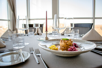 Pike cutlet with pumpkin sauce and fermented cabbage in different colors at a restaurant