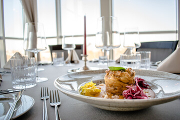 Pike cutlet with pumpkin sauce and fermented cabbage in different colors at a restaurant