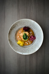 Pike cutlet with pumpkin sauce and fermented cabbage in different colors at a restaurant