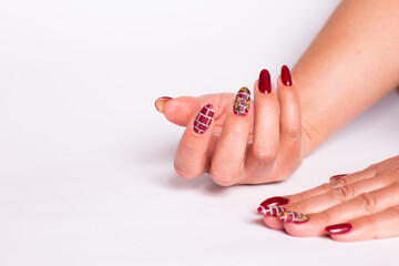 Manicure with pattern. Female hands with manicure on a white.