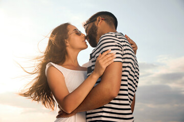 Fototapeta premium Lovely couple enjoying each other against sunny sky