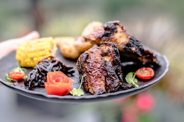 Fried ribs witch sauce and vegetables prepared at a restaurant