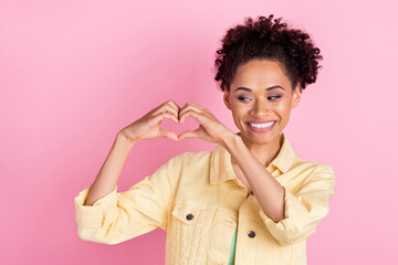 Fototapeta na wymiar Photo of lovely millennial brunette lady show heart wear yellow shirt isolated on pink color background
