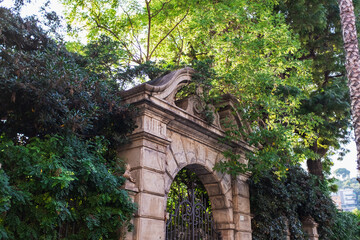 old stone gate surrounded by trees