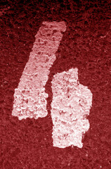 Number four on asphalt in red tone.