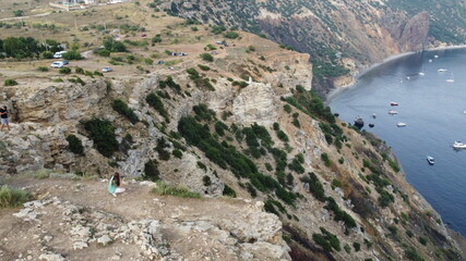 A girl with a camera on Cape Fiolent near the city of Sevastopol in Crimea