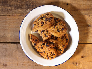 top view of handmade chocolate chip cookies on a rustic wood background