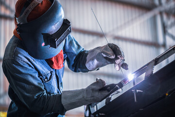 Industrial welder welding fabricated stainless construction work in factory, Welding process by Gas Tungsten Arc Welding - GTAW.