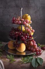 Still life with grapes shot against a dark background