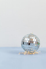 Disco ball against white and light blue background with empty space for text 