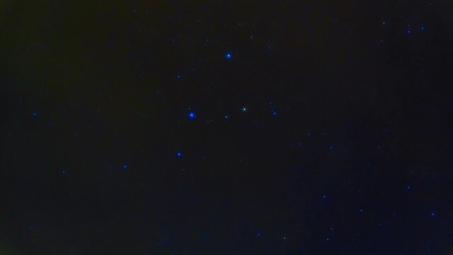Constellation Orion on background of night blue starry sky. Timelapse of night sky with galaxies, nebulae and space