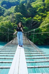 20s woman at the Suspension Bridge of Dreams in Shizuoka, Japan	
