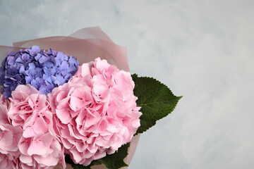 Bouquet of beautiful hortensia flowers on color background. Space for text