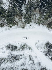 aerial view of off road vehicle in winter forest trail