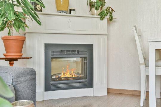 Fireplace with burning fire in modern apartment