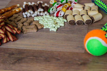 Dogs foods and bone shaped biscuits on wooden background