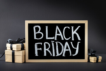 Black Friday background with blackboard inscription and gift boxes