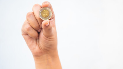 Indian girl showing head side of ten-rupee coin  