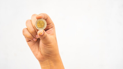 Fototapeta na wymiar Indian girl showing tails side of ten-rupee coin 