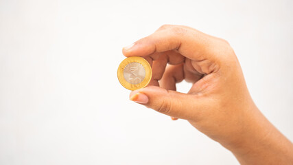 Indian girl showing a head side of ten-rupee coin  