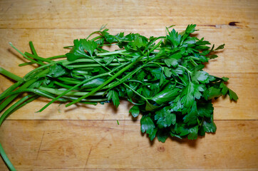 green parsley bundle on a wooden cutting board herb