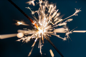 Bengal fire sparkles against the black background.