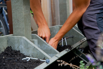 The making of a vertical green wall garden from recycled waste plastics, with substrate and an irrigation system with valves