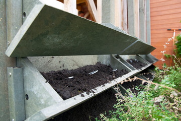 The making of a vertical green wall garden from recycled waste plastics, with substrate and an irrigation system with valves