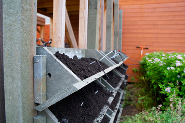 The making of a vertical green wall garden from recycled waste plastics, with substrate and an irrigation system with valves