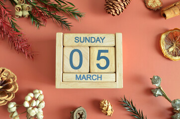 March 5, Cover design with calendar cube, pine cones and dried fruit in the natural concept.
