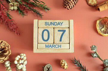 March 7, Cover design with calendar cube, pine cones and dried fruit in the natural concept.