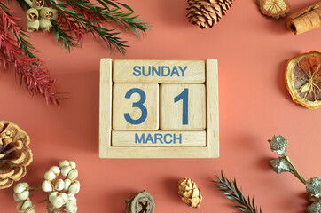 March 31, Cover design with calendar cube, pine cones and dried fruit in the natural concept.