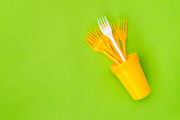 Different, unique white fork standing out of the crowd yellow forks