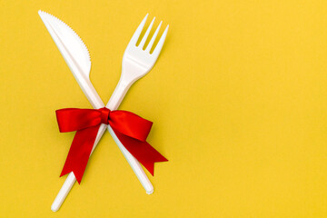 Disposable fork and knife decorated with red bow