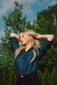 Beautiful Blonde In Demin Shirt With Trees On Background In Outdoor