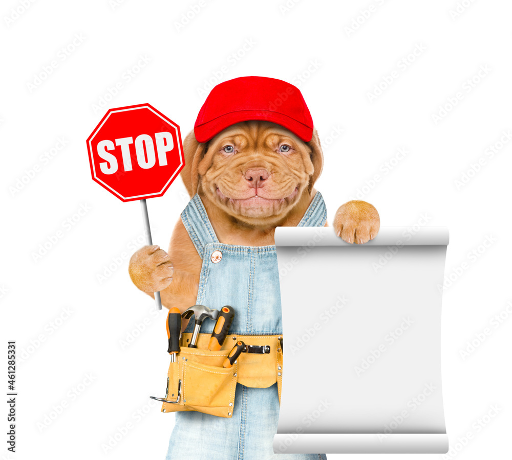 Poster Smiling puppy wearing overalls with tool belt and blue cap shows stop sign and empty list. Isolated on white background