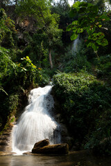 Fototapeta premium Beautiful landscape of waterfall in the fertile forests of Thailand