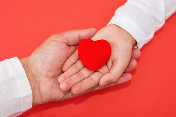 adults and children hands holding red heart, health care love, give, hope and family concept, world heart day, world health day