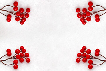 Red berries on a snowy background. Ideas for christmas time.