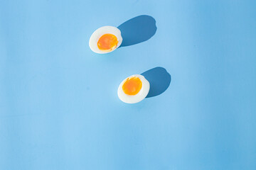 Cut boiled egg on a blue background