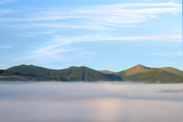 Fototapeta na wymiar Picturesque view of fog in mountains on morning