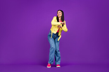 Fototapeta na wymiar Full length photo of young cheerful girl have fun dance party look empty space isolated over violet color background