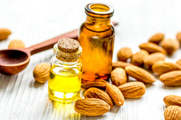 cosmetic set with almond oil on wooden table background