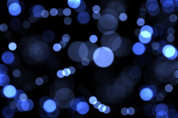 Fototapeta na wymiar Defocused blue lights on a dark background. Christmas background
