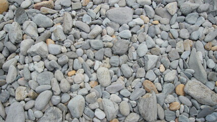 Smooth, gray rocks lining the shore of South Portland Maine. Worn down by the ocean.