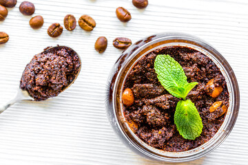 Organic spa with coffee scrub in cosmetic set on table top view
