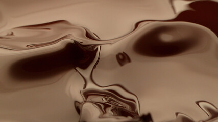 Macro photo of premium dark chocolate splashing.