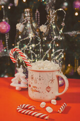 Christmas cocoa with marshmallows on the background of the Christmas tree