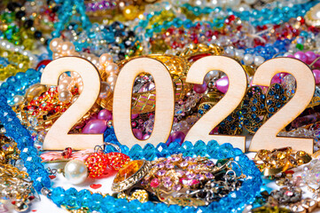number 2022 on a background of colorful and shiny jewelry, selective focus, closeup