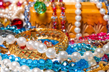 jewelry box, pearl beads and various other multicolored jewelry, soft focus, prosperity concept